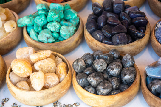 Close-up of bowls of assorted semi-precious stones on a table