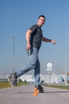 A Caucasian man rollerblades around the slalom course.