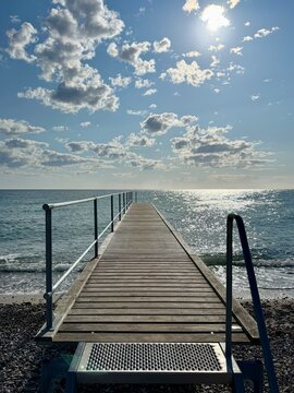 Empty wooden pier with steps into the sea on a summer morning, Nordby, Samsoe, Jutland, Denmark