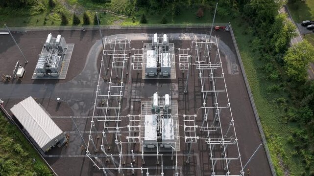 Aerial view of high voltage electrical substation with power transformers, busbars, circuit breakers, and steel support structures in New York, New York, United States.
