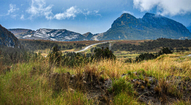 Road through an alpine landscape with Mt Trikora, Indonesian province of Papua, Papua, Indonesia