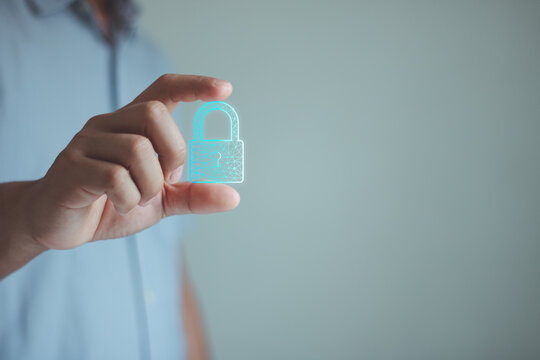 Cybersecurity, data protection technology concept. Person holding a glowing digital padlock icon isolated on a background. Access control, online security, information safety, digital identity trust.