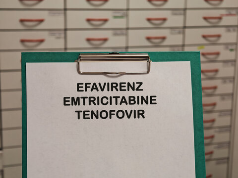 EFAVIRENZ EMTRICITABINE TENOFOVIR antiviral combination medicine for HIV or hepatitis viral infection displayed on a clipboard in a pharmacy healthcare concept
