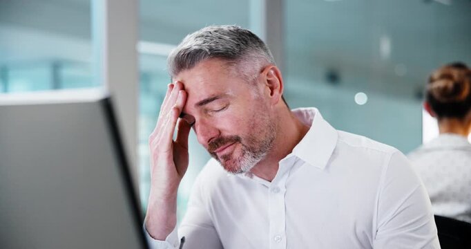 Computer, headache and man with stress in office, thinking or coworking with tax deadline. Tech, burnout and mature person with migraine for fraud investigation, wrong glasses and audit error