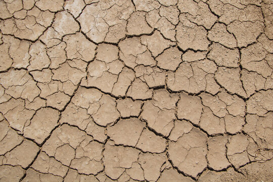 Cracked dry soil texture as drought and climate change concept background