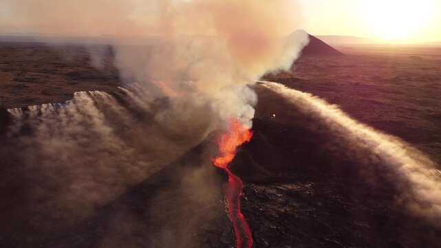 Aerial view of the Litli-Hrutur volcanic eruption with glowing lava flows and thick smoke plumes rising over the landscape in Grindavik, Grindavikurbaer, Iceland.