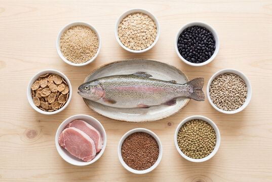 Fresh trout and grains arranged on table showing vitamin b1 rich food sources