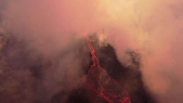 Aerial view of the Litli-Hrutur volcanic eruption with glowing lava flows and thick volcanic smoke rising from the crater in Grindavik, Grindavikurbaer, Iceland.