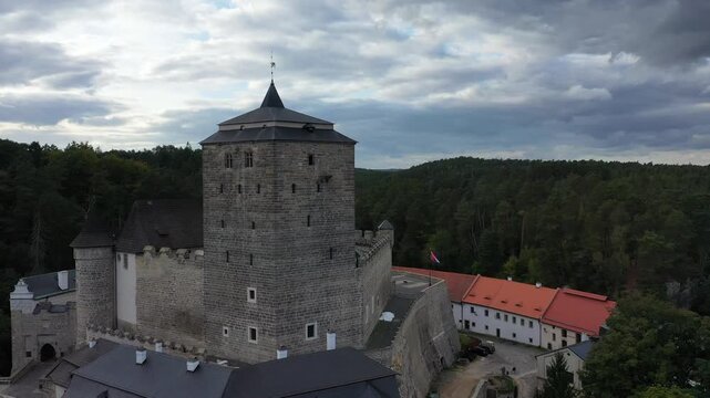 Aerial view of the historic Kost Castle with its stone tower and surrounding forest in Libosovice, Kralovehradecky kraj, Czechia.
