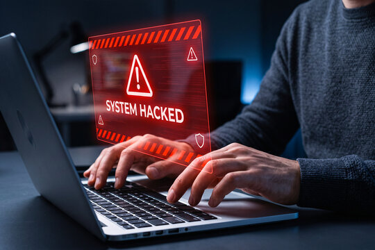 System hacked warning on laptop as user types, showing cybersecurity breach alert, malware attack, compromised network, data theft risk, digital security failure and incident response technology