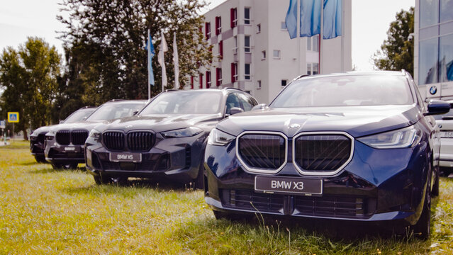 Riga, Latvia - July 15, 2026: The photo shows a new blue Volkswagen car in the background is a glass display case of a car dealership