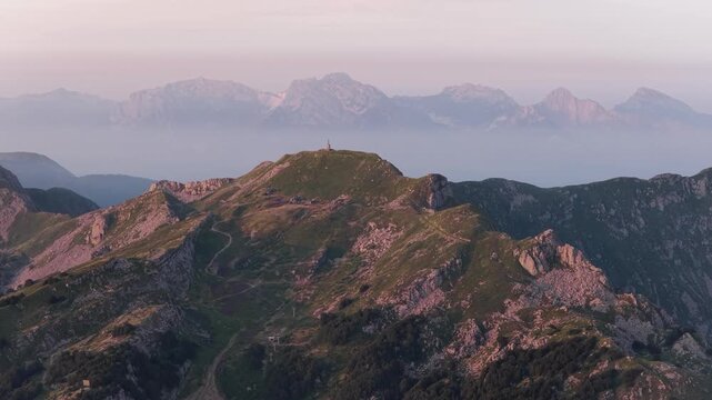 Aerial view of the mountain landscape of Cerreto Laghi at sunrise with rocky peaks and lush green slopes in Cerreto Laghi, Emilia-Romagna, Italy.