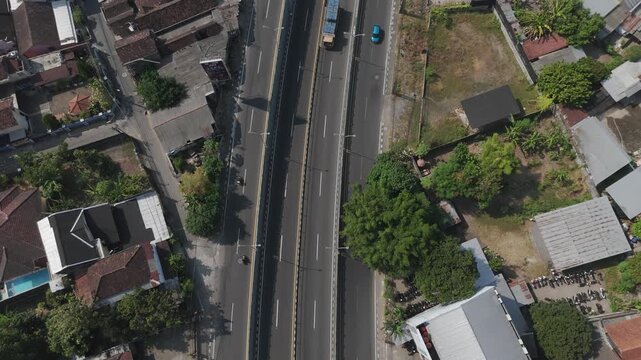 Aerial view of Underpass Kentungan with surrounding urban buildings and lush greenery in Kecamatan Depok, Daerah Istimewa Yogya, Indonesia.