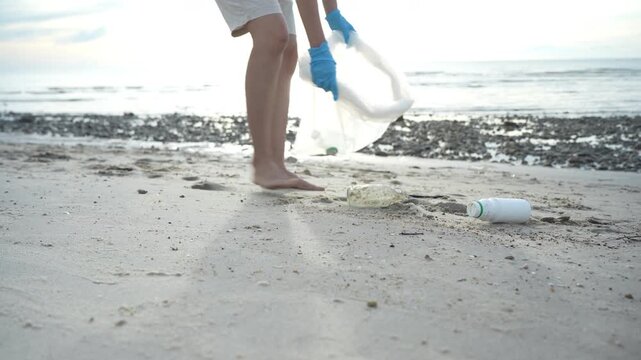 Save ocean. Volunteer pick up trash garbage at the beach and plastic bottles are difficult decompose prevent harm aquatic life. Earth, Environment, Greening planet, reduce global warming, Save worl