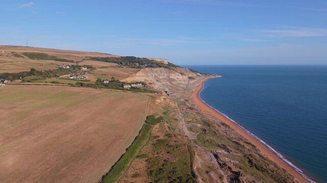 Aerial drone footage of Chale village on the Isle of Wight, England, showcasing the rural village, surrounding countryside, and rolling landscape in warm evening light