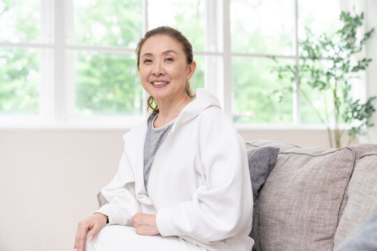 部屋でリラックスするシニア女性
