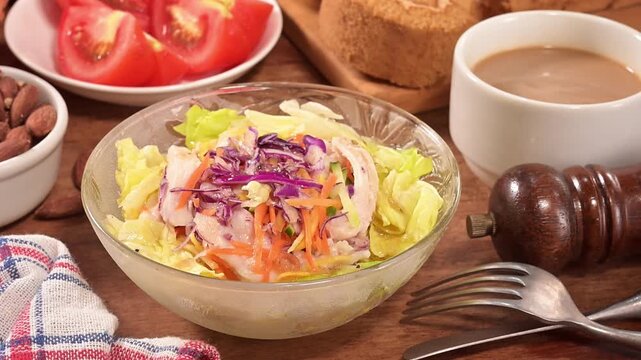 Shredded chicken salad with scallion and sald dressing in glass bowl