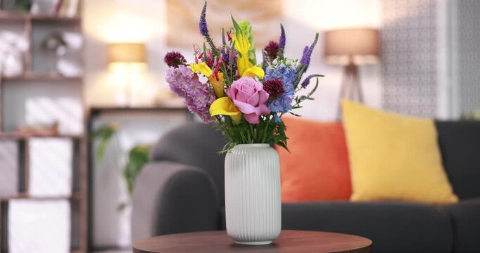 Bouquet of beautiful summer flowers in vase on wooden table indoors