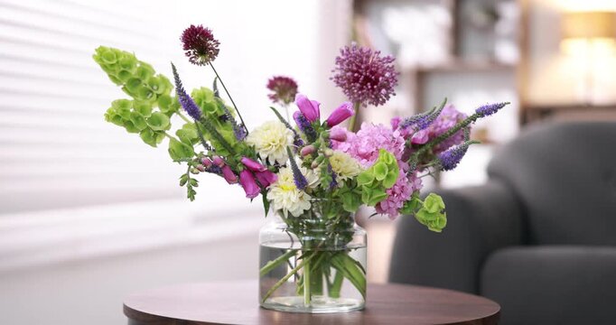 Bouquet of beautiful summer flowers in vase on wooden table indoors, closeup
