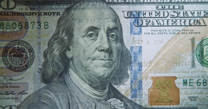 Close-Up of 100 US Dollar Banknote Verified with Light for Authenticity
