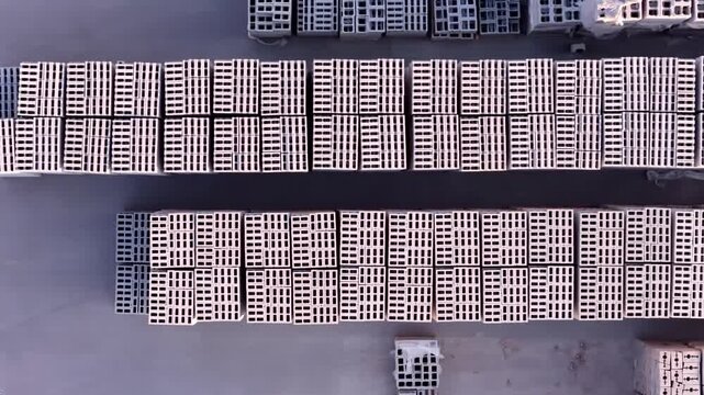 Aerial view of stacks of concrete masonry blocks and pavers arranged in a manufacturing yard in Bluffdale, Utah, United States.