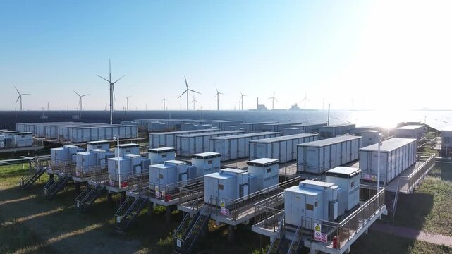 Offshore wind farm with battery energy storage system arrays under clear blue sky