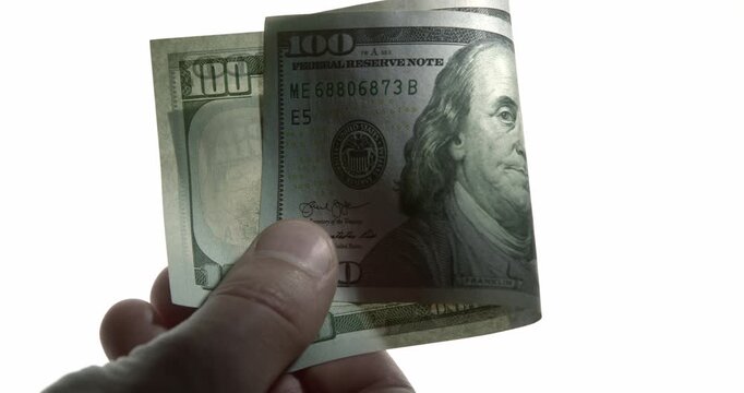 Close-Up of US Dollar Banknotes Exchanged as Bribe in Dramatic Light