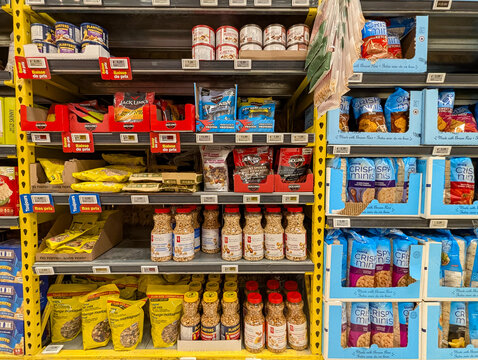 Quebec, Canada, 16 May 2026 : Grocery store shelves display packaged food products, including Jack Link's jerky and Quaker Crispy Minis.