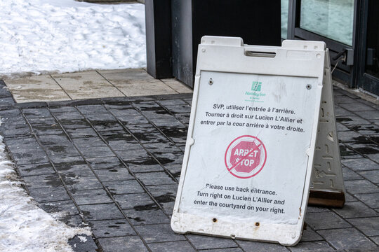 MONTREAL, CANADA, 25 December 2025 : Sign, Snowy Sidewalk, Back Entrance Directions