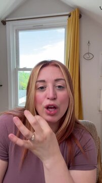 woman does a series of hushing reactions as if to say - I have a secret