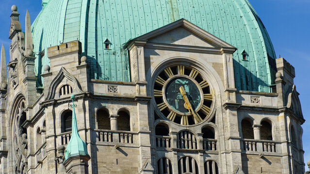 Hanover, Germany - 24 July 2026: View of the New Town Hall clock tower with its distinctive green dome and intricate stone architecture under a clear blue sky.