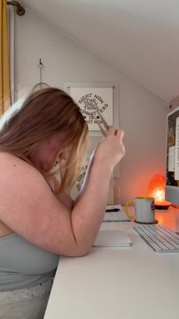 tired woman takes off glasses, is disappointed, and puts hands in face in front of the computer