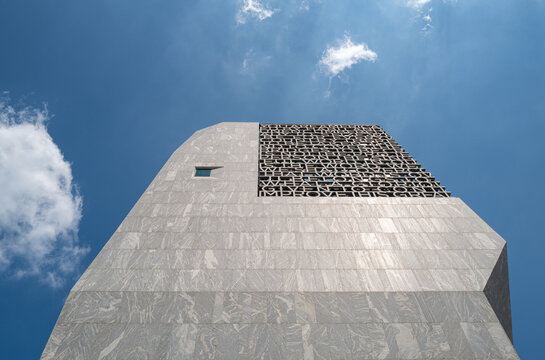 Looking to sky with view of carved speech text from President Obama's 2015 Selma address on the concrete facade of the Obama Presidential Center tower in Chicago's historic Jackson Park. July 2026