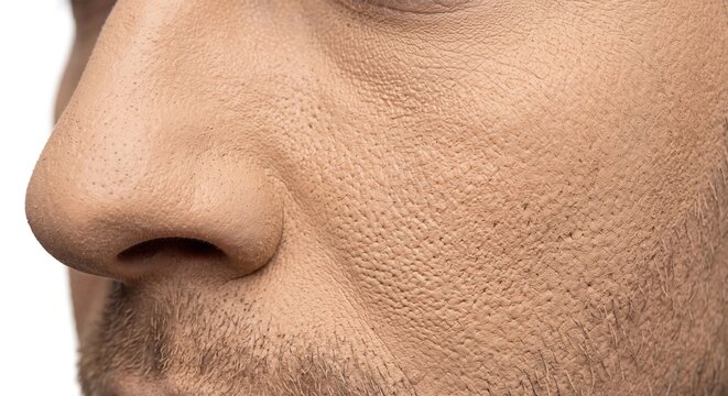 Extreme macro close up of male face cheek showing caked powdery makeup texture and visible skin pores