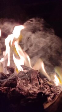 Bright flames burning against a dark background, showcasing intense fire, glowing embers, and dramatic contrast.
