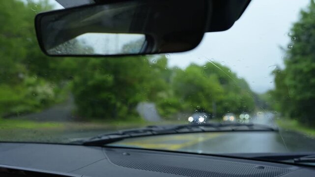 Summer drive in Nova Scotia with lush greenery and gentle rain