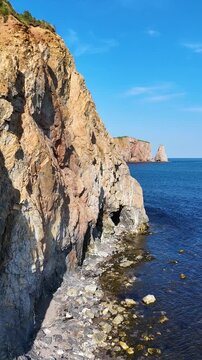 Aerial drone view of Perc&eacute; Rock and rugged coastline in Gasp&eacute;sie, Quebec.
