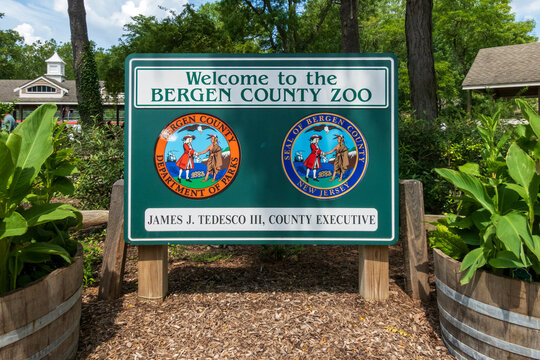 Paramus, NJ - US - Aug 2, 2026 Entrance sign for Bergen County Zoo in New Jersey, surrounded by lush greenery, featuring official seals and welcoming visitors to the park on a sunny day.