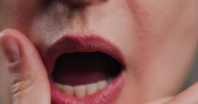 Close-up view of a person's open mouth showing teeth and inner lips