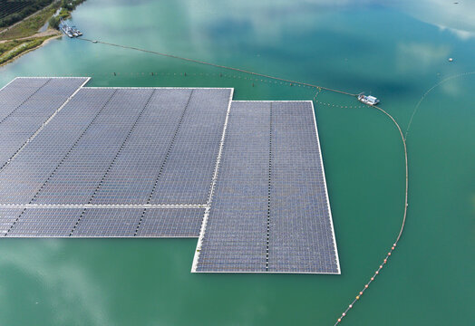 Aerial view of the floating solar farm on Lingemeer, featuring rows of photovoltaic panels on the turquoise water surface in Buren, Gelderland, Netherlands.