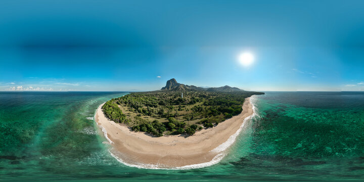 Aerial view of Nuca Molas island featuring a sandy beach, lush tropical vegetation, and a prominent hill surrounded by turquoise waters in Satar Mese Barat, East Nusa Tenggara, Indonesia.
