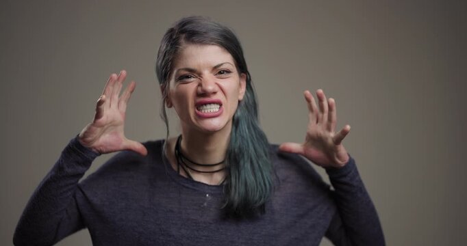 Angry woman with expressive face pulling hair in frustration