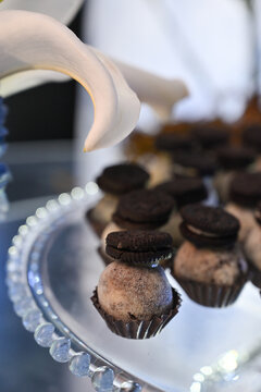 gourmet chocolate truffle topped with chocolate sandwich cookie close up, elegant party dessert on glass tray with lily petal decor, brazilian gourmet party candy stock photography