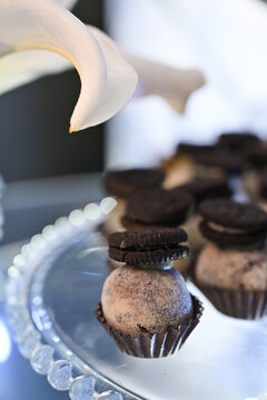 gourmet chocolate truffle topped with chocolate sandwich cookie close up, elegant party dessert on glass tray with lily petal decor, brazilian gourmet party candy stock photography