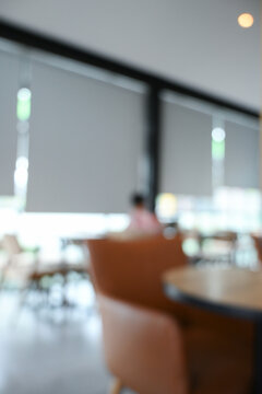 softy blurred view of a modern cafe or lounge interior featuring comfortable chair and round table