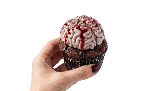 Hand holding a bloody brain cupcake. Spooky Halloween dessert