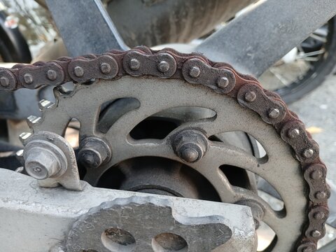 Close-Up of a Rusty Drive Chain and Rear Sprocket on a Motorcycle
