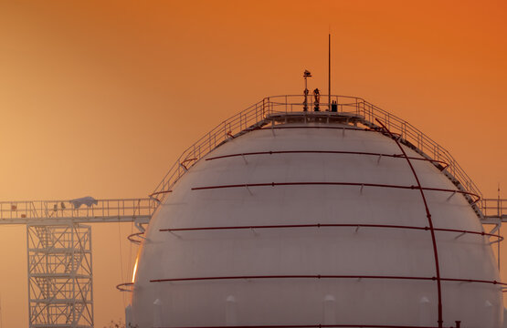 Large spherical LNG storage tank at petroleum refinery. Natural gas infrastructure, industrial energy storage, engineering technology and global fuel supply facilities. Infrastructure investment.