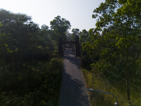 Aerial view of the entrance to The Lost World Castle surrounded by lush green forest and trees in Kecamatan Cangkringan, Daerah Istimewa Yogya, Indonesia.