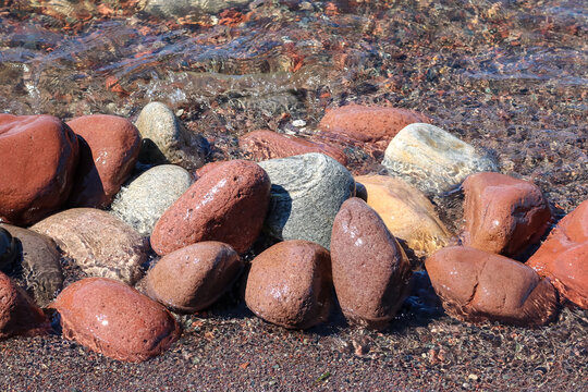 Rocks on the Lake Superior beach at McClain State Park between Houghton and Calumet, MI. The red rocks contain oxidized iron deposits. 